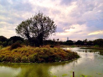 Scenic view of lake against cloudy sky