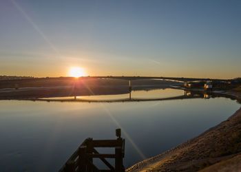 Scenic view of lake against sky during sunset