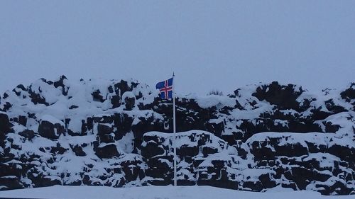 Scenic view of snow covered landscape against clear blue sky