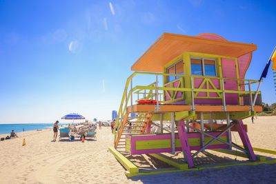 Lifeguard hut on beach against sky