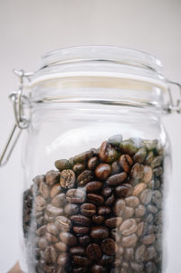 Close-up of coffee beans in glass jar on table