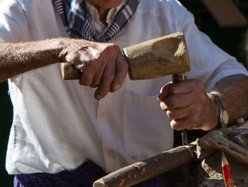 Midsection of man holding hands