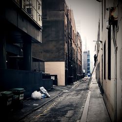 Empty alley amidst buildings in city