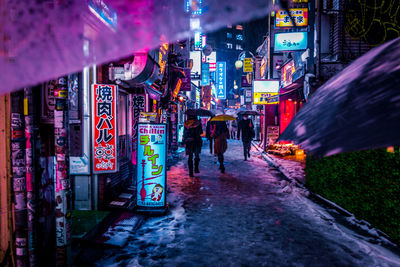 Illuminated city street at night