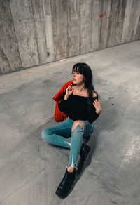 Young woman sitting in garage