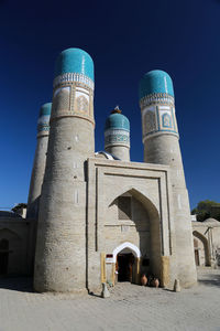 Low angle view of historical building against blue sky