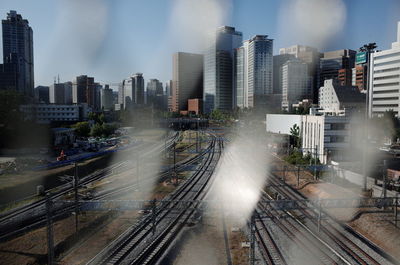 High angle view of railroad tracks amidst buildings in city