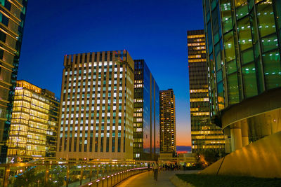 Low angle view of modern buildings against clear sky at night