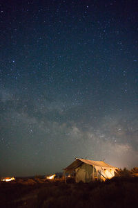 Scenic view of illuminated building against sky at night