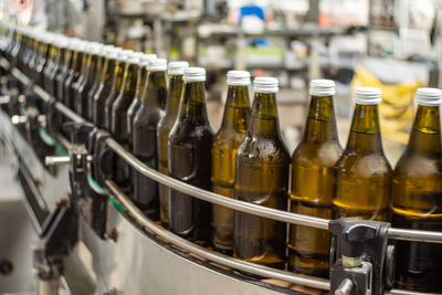 Row of wine bottles in glass