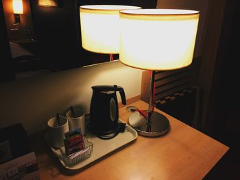 Illuminated electric lamp on table