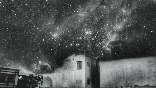 Illuminated house against sky at night