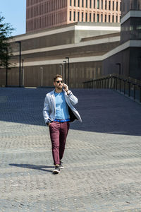 Man talking on phone while walking on street