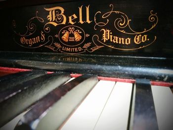 Close-up of text on old piano