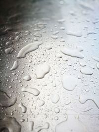 High angle view of raindrops on glass