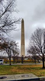 Statue in park with city in background