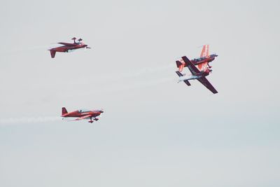 Low angle view of airshow against sky