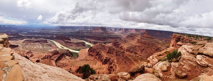 Panoramic view of desert against cloudy sky