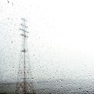 Close-up of wet rain against sky