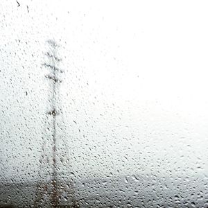 Close-up of wet rain against sky