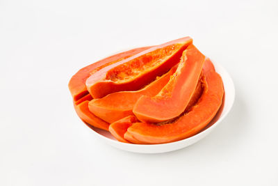 High angle view of orange fruit on white background