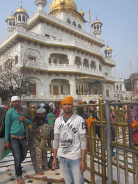 Portrait of man standing in front of historical building