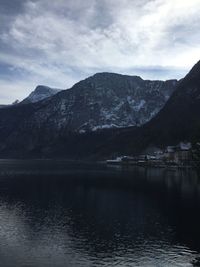 Scenic view of lake by mountains against sky