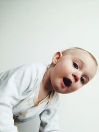 Portrait of cute baby girl against white background