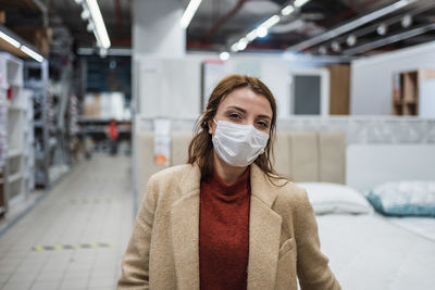 Portrait of woman wearing mask at shopping mall