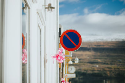 Close-up of road sign against sky