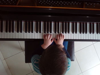 Directly above shot of boy playing piano