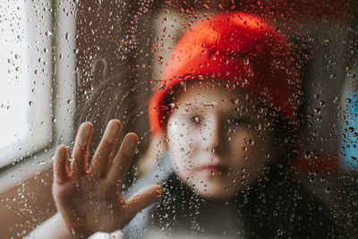 Close-up portrait of wet glass window in rainy season