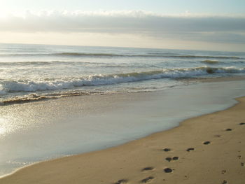 Scenic view of beach against sky during sunset