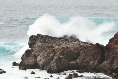 Waves splashing on rocks at shore