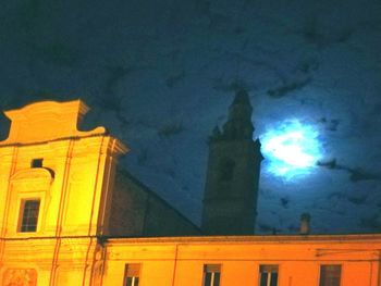 Low angle view of illuminated building against sky at night