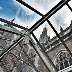 Low angle view of building against cloudy sky