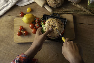 High angle view of person preparing fruits on cutting board