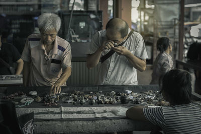 Men looking antiques in shop