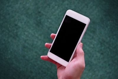 Close-up of hand holding mobile phone