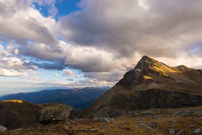 Scenic view of mountains against cloudy sky