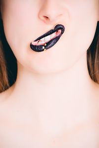 Close-up of young woman over white background