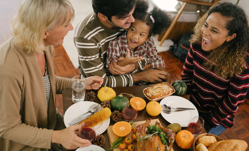 People sitting by food on table