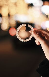 Close-up of hand holding illuminated lights
