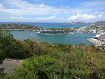 Boats moored at harbor against sky