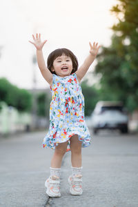 Full length of cute girl standing on road