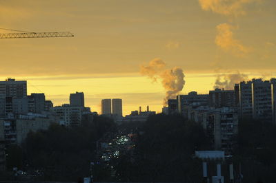 Silhouette cityscape against sky during sunset