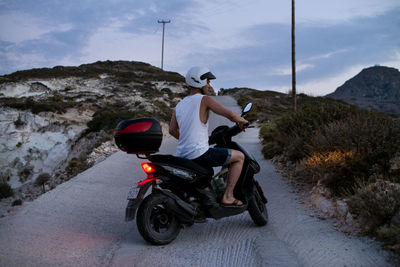Woman riding motorcycle on road