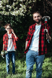 Portrait of smiling man with son walking outdoors