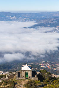 Scenic view of buildings and mountains against sky