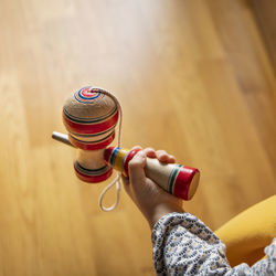 High angle view of person playing cup and ball toy